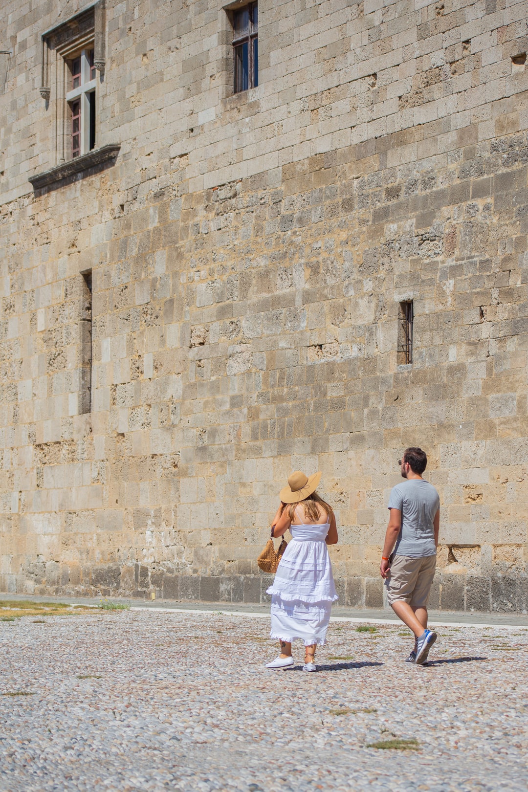 A couple walking around the Old Town in Rhodes, shot from the back to avoid the massive iced coffee stain on the front of this poor womans dress that happened minutes before.